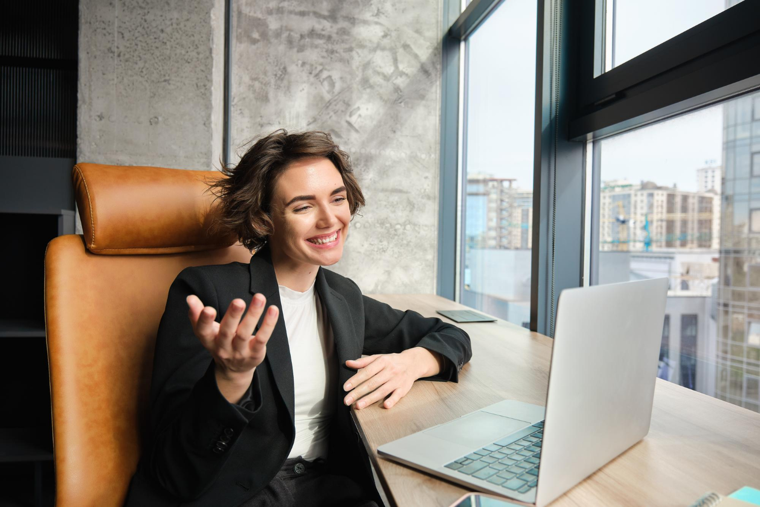 Woman smiling at a laptop